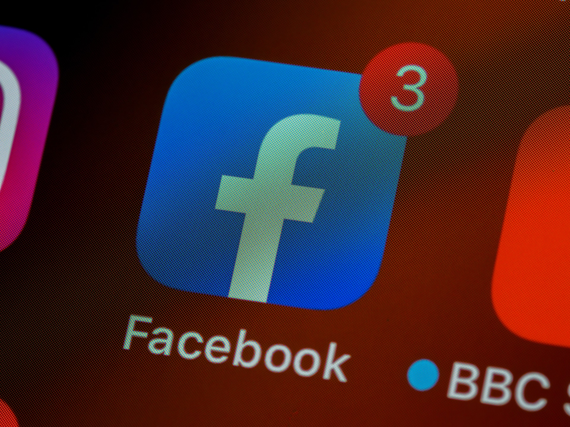 The facebook app-icon being shown on an iphone